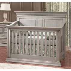 a baby crib in a room with dressers