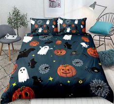 a bed covered in halloween themed sheets with ghost and jack - o'- lanterns