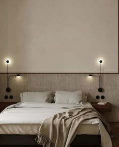 a large bed sitting in a bedroom next to two lamps on either side of it