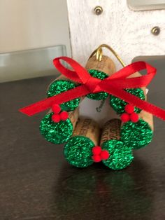 an ornament made out of wine corks with red ribbon