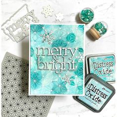 some crafting supplies are laying out on a white counter top with the words merry and bright