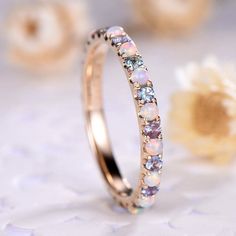 a close up view of a ring with opal stones on the inside and outside