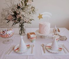 a table topped with cake, candy and flowers