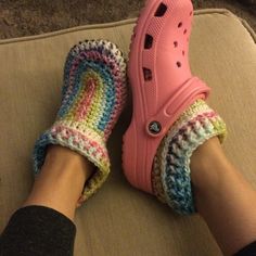 a person's feet wearing crocheted slippers on top of a couch