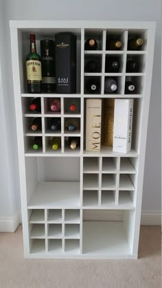 a white book shelf filled with lots of bottles