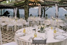 tables and chairs set up for an outdoor wedding reception