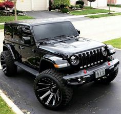 a black jeep parked in front of a house