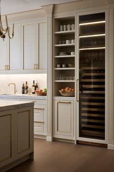 a kitchen filled with lots of white cabinets