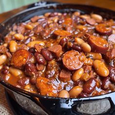 beans and sausages are cooked in a skillet