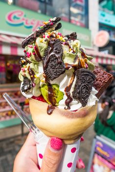 an ice cream sundae with oreo cookies and sprinkles