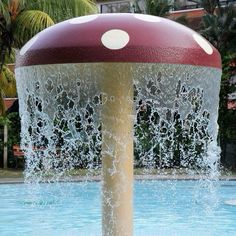 a water fountain with a red and white top