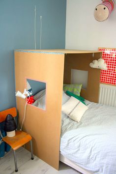 a room with a bed made out of cardboard