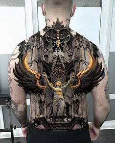 the back of a man with tattoos on his body