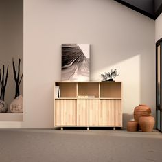 an empty room with two vases on the floor and a book shelf in front of it