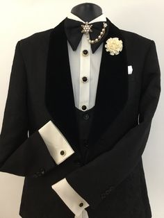 a black tuxedo with white lapel collar and flower brooch