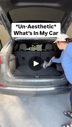 a woman is opening the trunk of a car