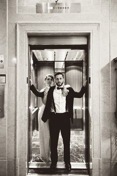 a man and woman standing in an elevator