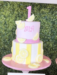 a pink and yellow cake sitting on top of a table