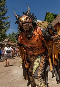 a man in costume walking down a dirt road