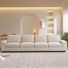 a living room filled with white furniture and lots of windows