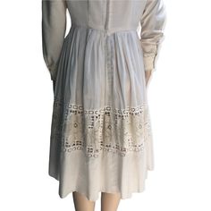 "Here I have a lovely cream dress made by Lou Ross of California in the 1950s.  It features a fine semi transparent pleated skirt with a panel of lace roses around the mid skirt.  Some of the lace has come away in the back please see photos priced accordingly.  This dress has long sleeves which may have been added by the previous owner.  Metal zipper in great working condition. Diamond lace panel around the neckline. One small mark on the back, all in all this is a really sweet dress.  No sizing Knee-length Cream Dress With Lace Patchwork, A-line Vintage Dress With Lace Trim, Cream Lace Trim Midi Dress For Wedding, Elegant Vintage Dress With Lace Work For Spring, Vintage Midi Dress For Casual Occasions, Vintage Dresses With Lace Work For Garden Party, Classic Cream Dress For Vintage Events, Vintage Lace Work Dresses For Garden Party, Beige Lace Trim Midi Dress For Garden Party