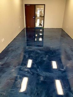 an empty room with blue floors and white walls