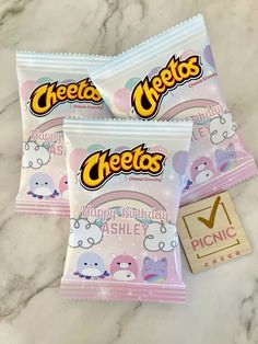 three cheetos candy bars sitting on top of a marble counter next to a sticker