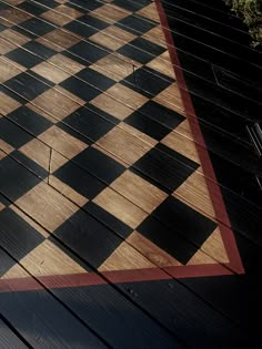 a black and white checkerboard pattern on a wooden floor