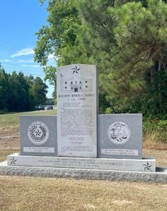 the monument is in front of some trees