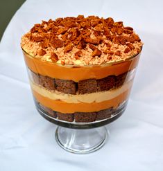 pumpkin gingerbread toffe crunch trifle in a glass dish on a white tablecloth