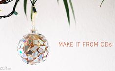 an ornament hanging from a tree branch with the words make it from cds