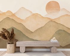 a wooden bench sitting in front of a wall with mountains painted on it and a potted plant next to it