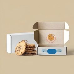 an open box of cookies next to a stack of cookies