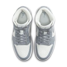 The iconic Air Jordan 1 Mid has been a staple of street style since its debut over two decades ago. Now, a new version brings the timeless design into modern fashion in grey sail tones. This sleek rendition offers an elevated, versatile style with subtle tones that are sure to stand out. The classic silhouette’s upper is crafted from quality leather and suede materials that luxuriously hug your foot for all-day comfort. The dark shade of grey makes the shoe versatile and wearable for any occasio Jordan 1 Mid Stealth, Air Jordan 1 Mid Grey, Jordan 1 Mid Women, Nike Tenis, Jordan Shop, All Jordans, Transition Outfits, Adidas Spezial, Wings Logo