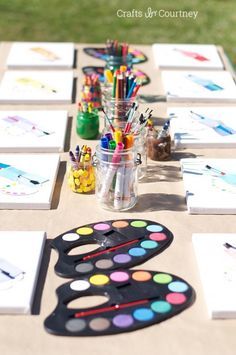 the table is set up with art supplies