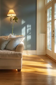 a living room with hard wood floors and blue walls