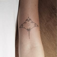 a small tattoo on the arm of a woman