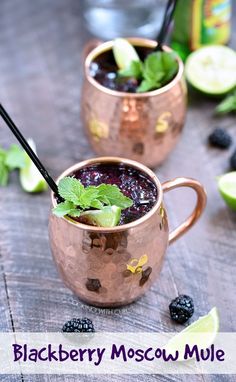 two copper mugs filled with blackberry moscow mule