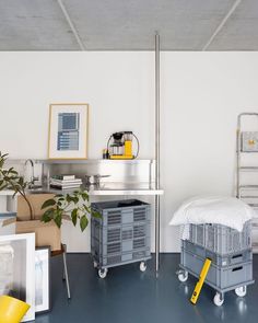 there is a bed and some crates on the floor next to each other in this room