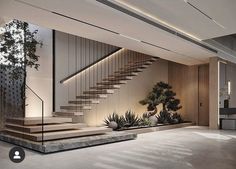 an indoor staircase with plants and potted trees in the center is lit by recessed lighting