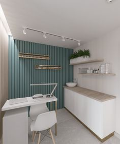 a white desk sitting next to a counter in a room with shelves and plants on the wall