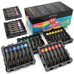 an assortment of arttea watercolor pencils in black boxes with their lids open