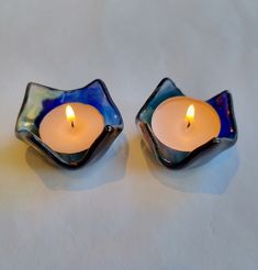 Rainbow colored glass candle holders. This colorful handmade pair of tea light holders would make a beautiful gift. The candle casts gorgeous colors across the surface when lit. These  items are made from recycled glass which I cut by hand, painted and fired in my kiln. The glass is cooled slowly overnight in the kiln for maximum strength. It is then fired again, draped  over a mould to create the unique shape. These small candle holders measure 5.5 cm wide,  3 cm high and and are 3mm thick. The Shabbat Candlesticks, Small Candle Holders, Tea Light Holders, Tealight Candle, Tealight Candle Holders, Glass Candle Holders, Home N Decor, Tealight, Tea Light Candles