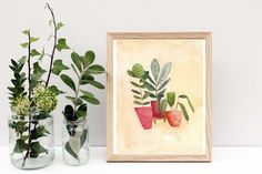 three potted plants sit next to each other on a white shelf with a framed photograph