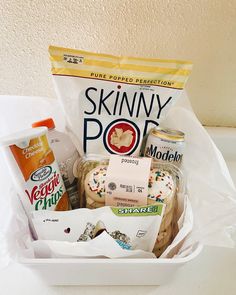 a white basket filled with food sitting on top of a counter