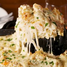 a spatula scooping out some food from a casserole dish on a plate