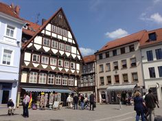 people are walking around in front of some buildings