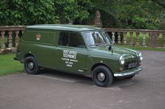 an old green van is parked in the driveway