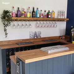 a bar with several bottles and glasses on the wall above it, along with an air freshener dispenser