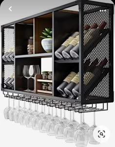 the wine rack is filled with many bottles and glasses